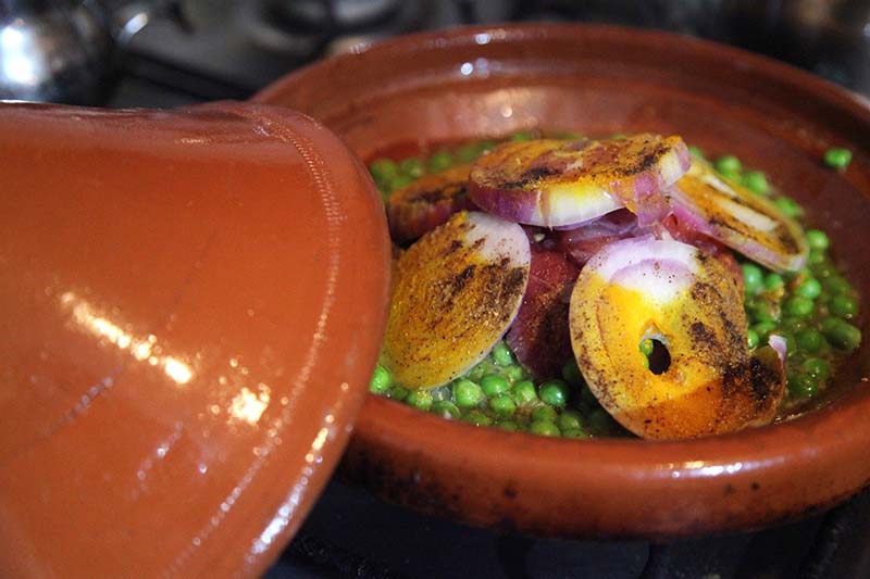 Cibo maghrebino con piselli, cipolla e curcuma
